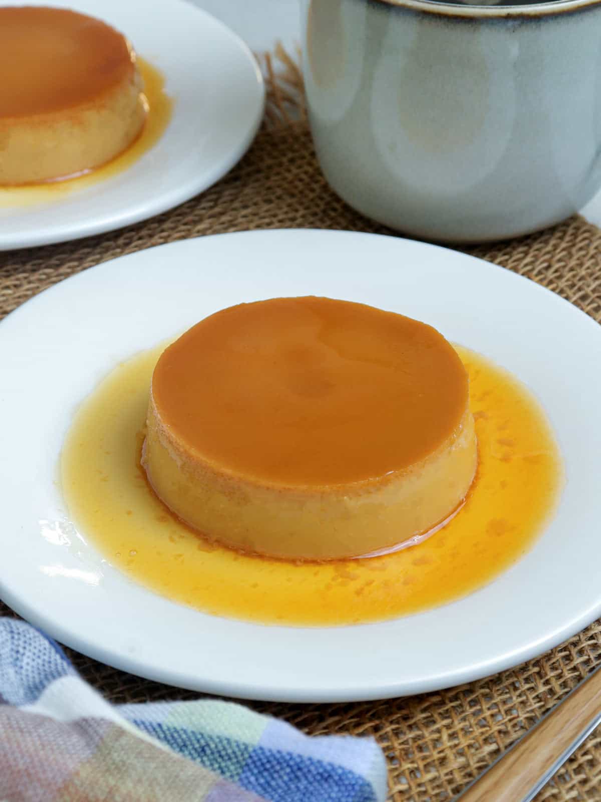 caramel flan on white plate.