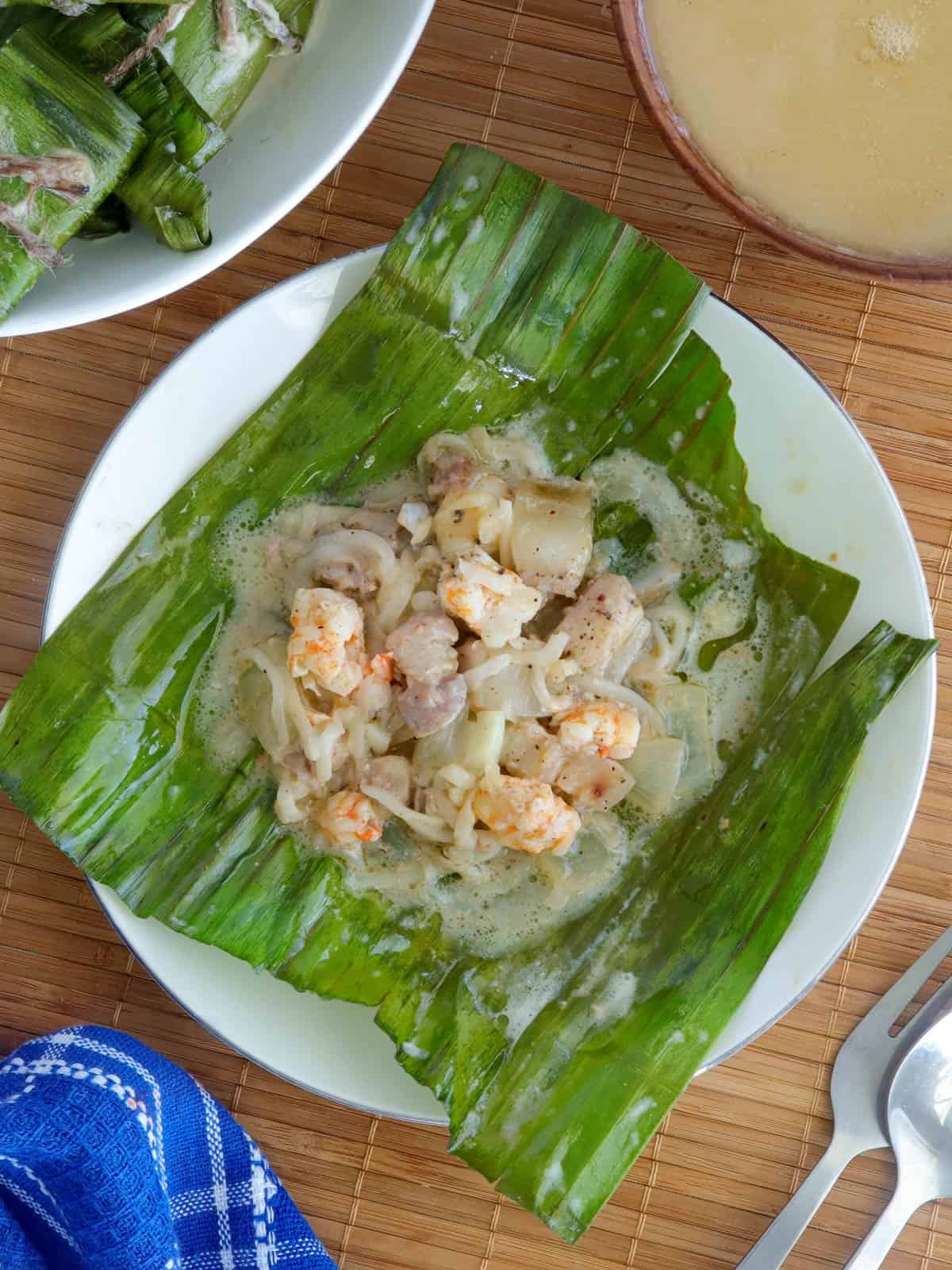 top view of pinais Pinais na Hipon on a banana leaf on a white plate.