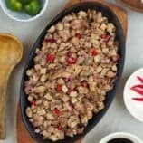 pork sisig on a cast-iron sizzling plate.