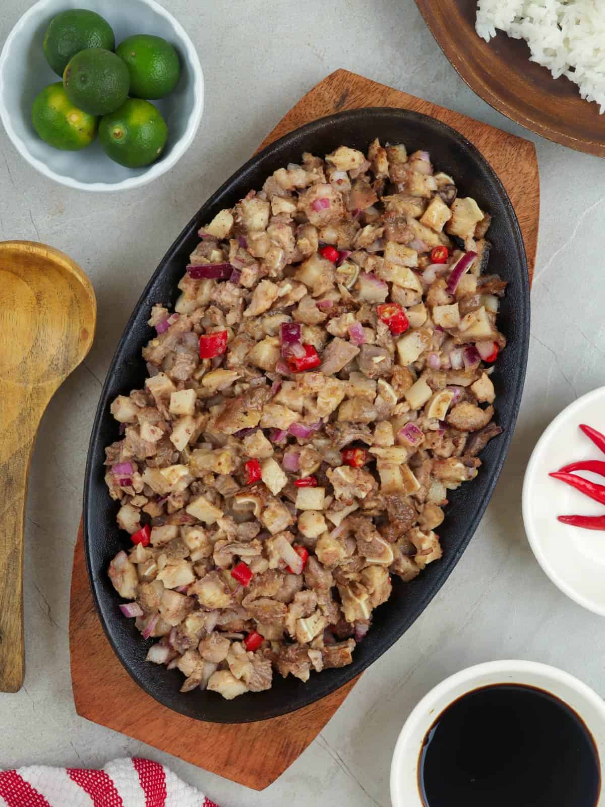 pork sisig on a cast-iron sizzling plate.